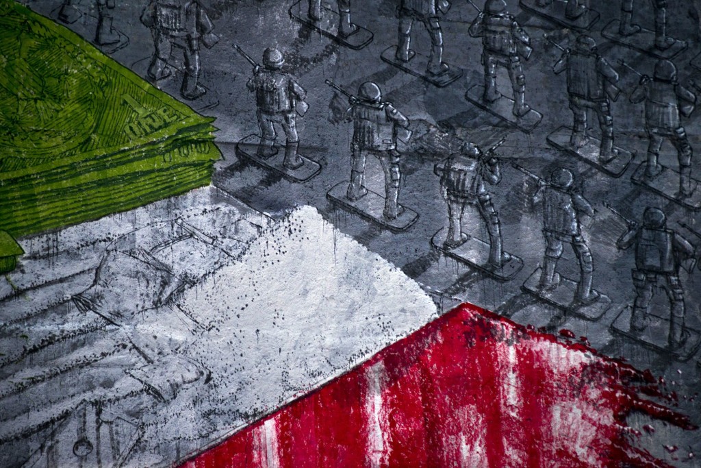 A mural by Blu, an Italian artist who has been compared to Banksy in both their work and hidden identity, shows Mexican and American toy soldiers lining a Mexican flag made by green dollars, white cocaine, and red blood.