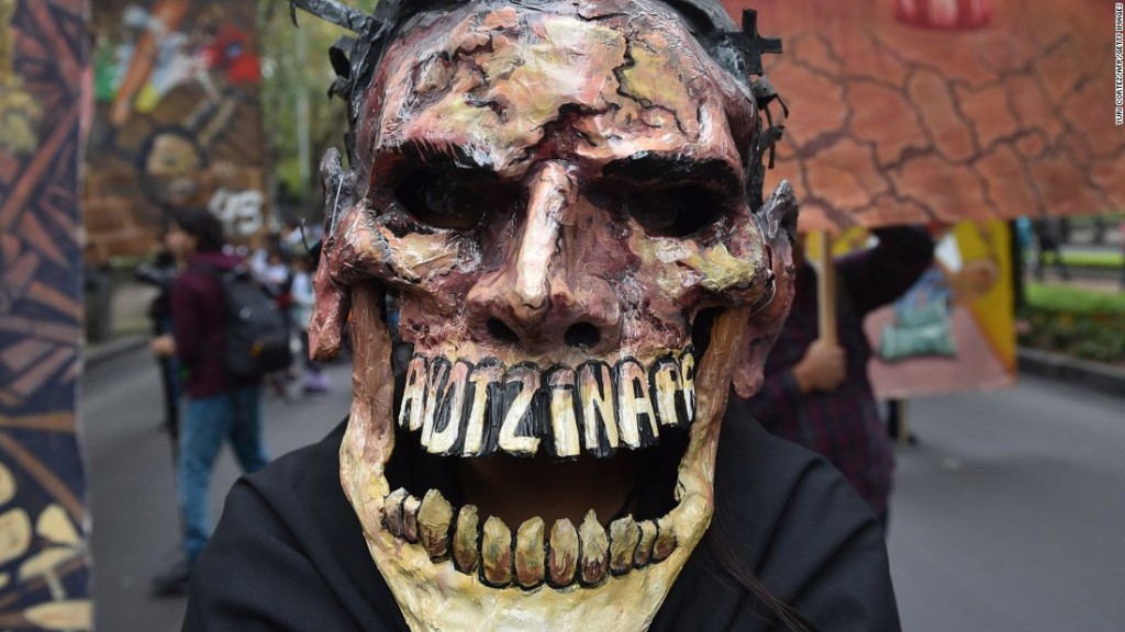 The skull mask, a common motif in Mexican folk art, is used in an unusually sinister manner to protest the students' mysterious disappearance and death (CNN.)