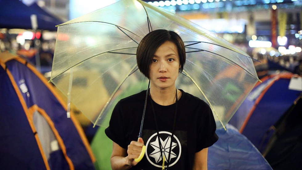 Denise Ho wears the emblem of Hong Kong Shield while carrying the yellow umbrella symbolic of the city's struggle for democracy (South China Morning Post.)